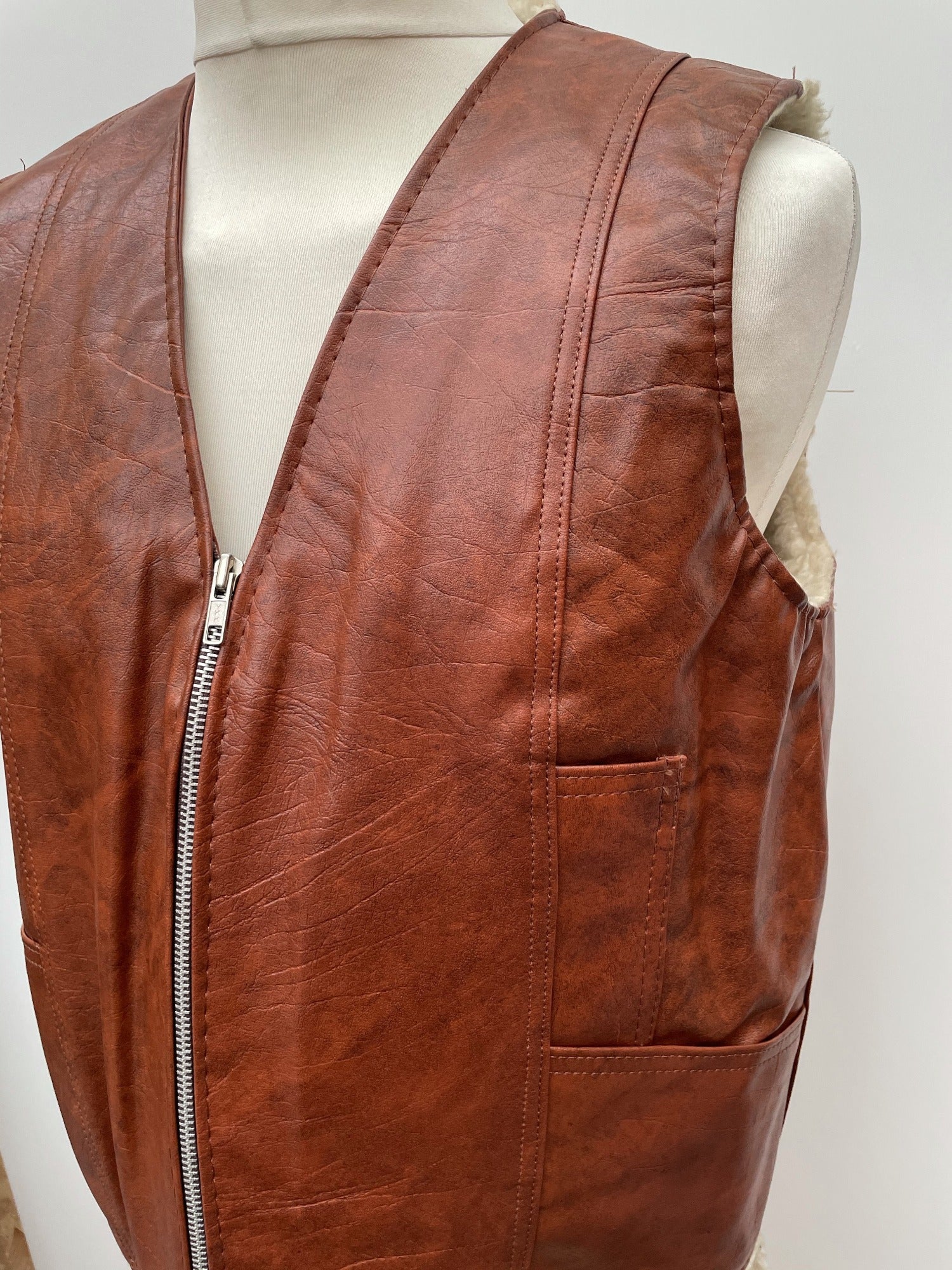 zip front  zip  waistcoat  Vinyl PVC  vintage  Urban Village Vintage  urban village  stitch detailing  stitch detail  sleevless  Sherpa  retro  PVC  polyester  pockets  mens  M  lined  light brown  Leather Jacket  Leather  Jacket  fully lined  fleece lined  Faux Leather  brown  70s  1970s