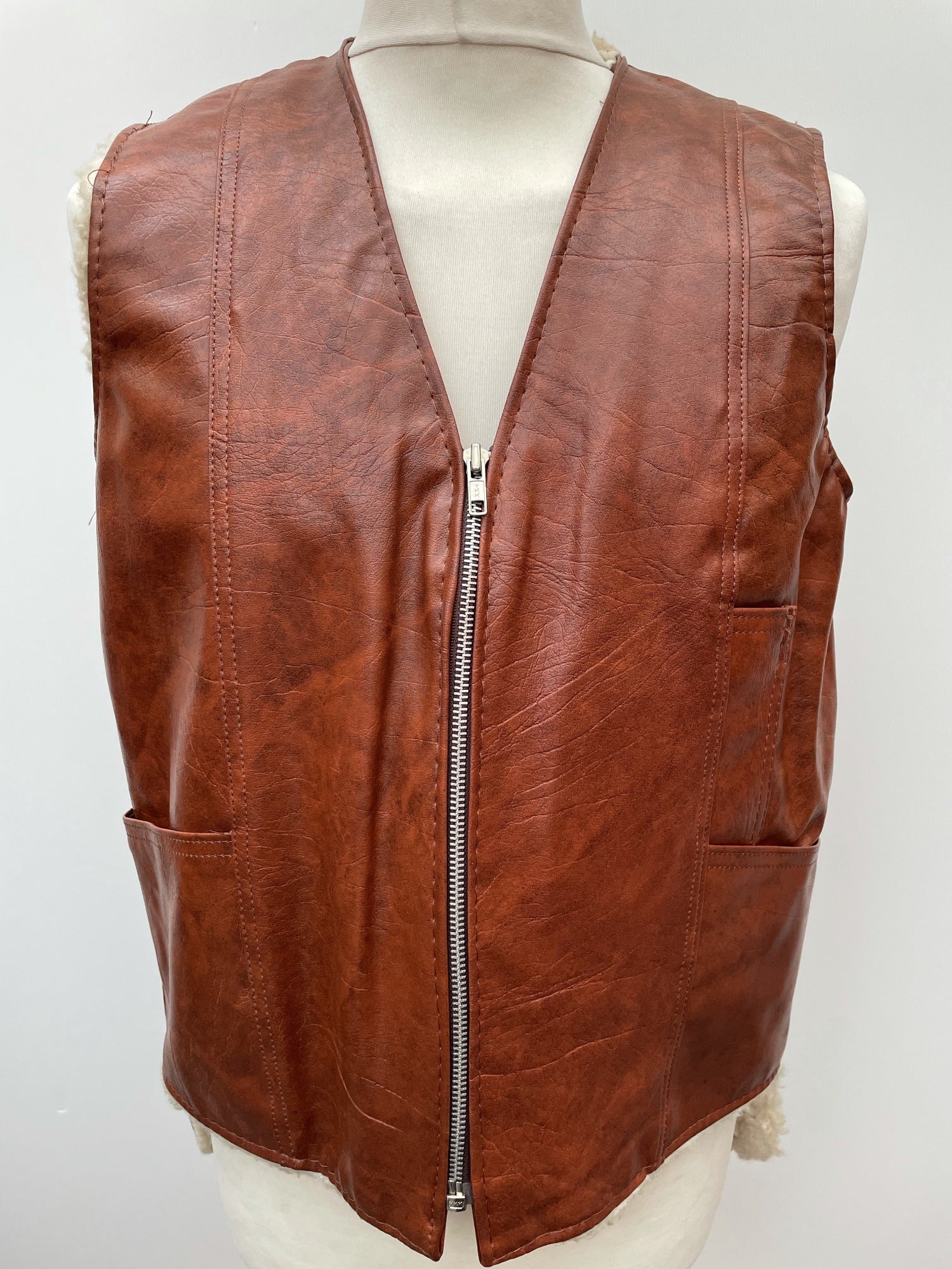 zip front  zip  waistcoat  Vinyl PVC  vintage  Urban Village Vintage  urban village  stitch detailing  stitch detail  sleevless  Sherpa  retro  PVC  polyester  pockets  mens  M  lined  light brown  Leather Jacket  Leather  Jacket  fully lined  fleece lined  Faux Leather  brown  70s  1970s