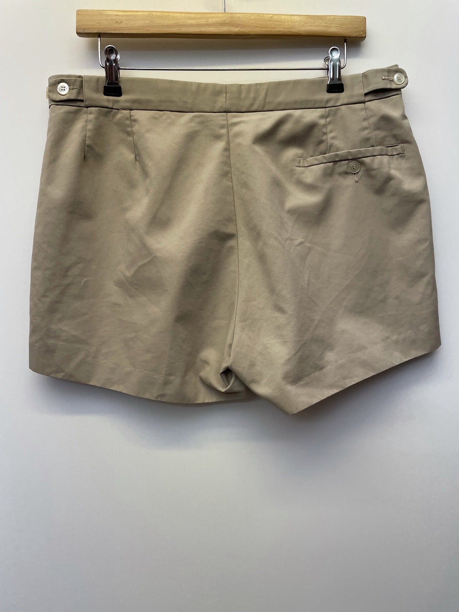 Mens original 1980s Fred Perry Sportswear shorts in tan. Zip fastening and waist button fastening adjustment with classic embroidered Fred Perry logo.